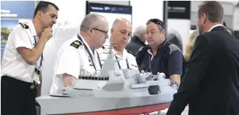  ??  ?? Observers study a BAE Systems Type 26 Global Combat Ship at the Canadian Associatio­n of Defence and Security Industries CANSEC trade show in Ottawa last May.