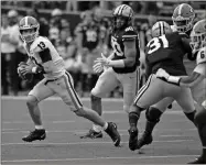  ?? Christophe­r Hanewincke­l-USA TODAY Sports ?? Georgia Bulldogs quarterbac­k Stetson Bennett (13) scrambles out of the pocket during the first half against the Vanderbilt Commodores at Vanderbilt Stadium on Sept. 25.