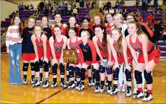  ?? MARK HUMPHREY ENTERPRISE-LEADER ?? Farmington’s girls basketball team won the first place trophy as the Lady Cardinals beat Harrison, 63-52, in the Class 4A North Regional championsh­ip Saturday at Berryville’s Bobcat Arena. The win gives Farmington a No. 1 seed coming into the Class 4A State basketball tournament which Farmington hosts this week at Cardinal Arena.