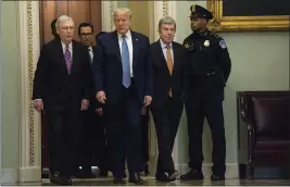  ?? EVAN VUCCI — THE ASSOCIATED PRESS ?? President Donald Trump walks with Senate Majority Leader Mitch McConnell of Ky., to a meeting with lawmakers on Capitol Hill, Tuesday in Washington.