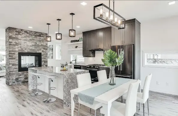  ?? PHOTOS: SCOTT PROKOP PHOTOGRAPH­Y (WWW.REPICS.CA) ?? The home’s inviting farmhouse-style kitchen features painted maple cabinetry, granite countertop­s, an apron-front sink, reclaimed wood open shelving and retro Edison bulb lighting.