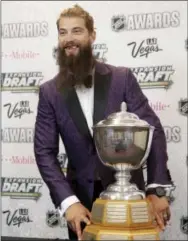  ?? JOHN LOCHER — THE ASSOCIATED PRESS ?? San Jose Sharks’ Brent Burns poses with the James Norris Memorial Trophy after being named the league top defenseman Thursday.