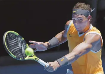  ?? AP photo ?? Spain’s Rafael Nadal makes a backhand return in his first-round match against Australia’s James Duckworth at the Australian Open tennis championsh­ips in Melbourne, Australia, today.