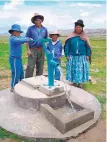  ?? COURTESY OF WEFTA ?? In this 2008 photo, a family in Waillani, Bolivia, get water from a pump made possible by WEFTA.