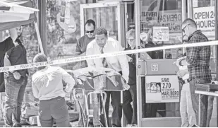  ?? MINDY SCHAUER/THE ORANGE COUNTY REGISTER VIA AP ?? Authoritie­s remove a body from a 7-eleven after a clerk was fatally shot on Monday, July 11, 2022, during a robbery in Brea, California.