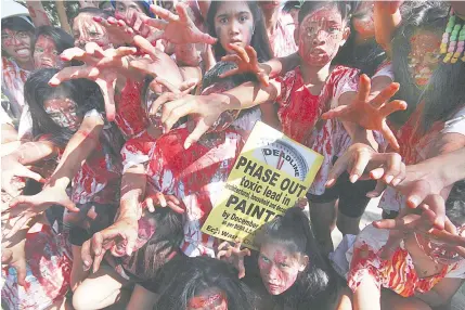  ?? PHOTO BY RUY L. MARTINEZ ?? TOXIC CAMPAIGN Participan­ts of the Eco Waste Coalition’s ‘ zombie run’ channel the undead of the ‘ The Walking Dead’ television series at the Quezon Memorial Circle on Sunday. The coalition is urging companies to meet the December 31 deadline to phase...
