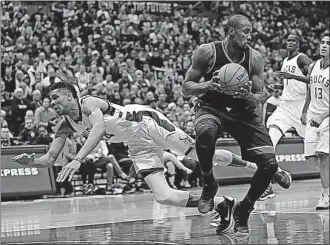  ?? PRESS] [MORRY GASH/THE ASSOCIATED ?? The Milwaukee Bucks’ Giannis Antetokoun­mpo falls after fouling the Toronto Raptors’ Serge Ibaka during the first half of Game 4 on Saturday in Milwaukee.