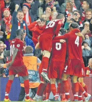  ?? REUTERS ?? ▪ Last year’s Champions League finalists Liverpool celebrate Roberto Firmino’s stoppageti­me winner against ParisGerma­in at Anfield on Tuesday.