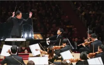  ?? XIAOJING WANG / FOR CHINA DAILY ?? Music director and chief conductor Lyu Jia conducts the NCPA orchestra in a performanc­e of the Yellow River Concerto with pianist Zhang Haochen at Carnegie Hall on Monday in New York.