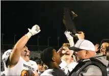  ?? MATTHEW MOWERY — MEDIANEWS GROUP ?? The Birmingham Brother Rice Warriors celebrate with the Division 3district championsh­ip trophy after beating No. 5Walled Lake Western, 30-22, on Friday.
