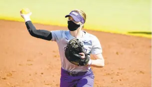  ?? AP FILE ?? James Madison’s Emily Phillips throws the ball to first base during an April 17 game.