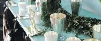  ??  ?? Mercury glass votive holders are paired with silver stocking hooks to bring a warm, sparkling glow. The winter months are the perfect time to embrace metallic decor, but keep in mind that “a little sparkle goes a long way.”