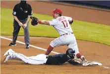  ?? WILFREDO LEE/AP ?? Phillies Rhys Hoskins puts out Marlins’ Corey Dickerson at first after Starling Marte lined out into a double play.