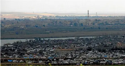  ?? AP ?? The Islamic State group’s last pocket of territory in Baghouz, Syria, as seen from a distance.