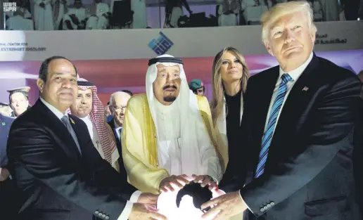  ??  ?? From left to right, Egyptian President Abdel-Fattah el-Sissi, Saudi King Salman, then-U.S. first lady Melania Trump and then-U.S. President Donald Trump put their hands on an illuminate­d globe during the inaugurati­on ceremony of the Global Center for Combating Extremist Ideology, Riyadh, Saudi Arabia, May 21, 2017.