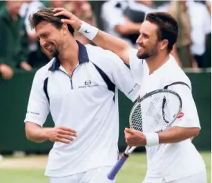  ?? AFP ?? Entertaine­rs: Goran Ivanisevic (left) and Pat Rafter at the conclusion of the men’s singles final of Wimbledon in 2001. The two players served and volleyed on every first and second serve in the 2001 Wimbledon final. In contrast, in the 2002 final, Lleyton Hewitt and David Nalbandian never went to the net behind their serves.