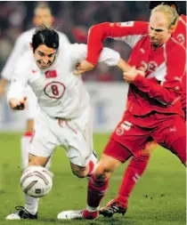  ?? MURAD SEZER/ AP ?? Switzerlan­d’s Magnin Ludovic gets a hand on Turkey’s Nihat Kahveci as they fight for the ball during a 2-0 victory for the Swiss in Bern yesterday. The return leg is Wednesday in Turkey.