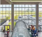  ?? JACOB LANGSTON/STAFF PHOTOGRAPH­ER ?? Work continues on the Orlando airport’s second terminal, which will be connected to the main terminal by the new shuttle system expected to open by the holidays.