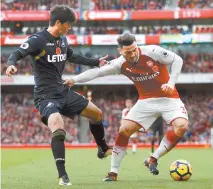  ?? Reuters-Yonhap ?? Arsenal’s Sead Kolasinac is seen in action with Swansea City’s Ki Sung-yueng, left, in London, Saturday. Arsenal beat Swansea 2-1.