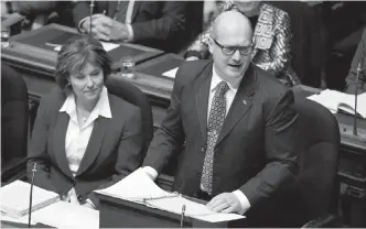  ??  ?? Premier Christy Clark looks on as Mike de Jong delivers Tuesday’s budget at the legislatur­e.