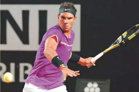  ??  ?? Rafael Nadal returns the ball to US Jack Sock during their third round match at the Italian Open last week. The Spaniard has won nine French Open titles.