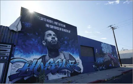  ?? CHRIS PIZZELLO — THE ASSOCIATED PRESS ?? A street mural of the late rapper Nipsey Hussle is pictured in June in the Boyle Heights section of Los Angeles.