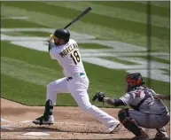  ??  ?? The Oakland Athletics’ Mitch Moreland (18) hits an RBI single in front of Houston Astros catcher Martin Maldonado during the first inning Saturday in Oakland.