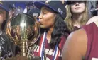  ?? HELEN COMER/DNJ ?? Riverdale's Anastasia Hayes kisses the Championsh­ip Trophy after Riverdale's victory over Memphis Central in Class AAA on March 11, 2017.