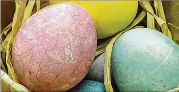  ?? AJC FILE ?? Egg decorating that relies on natural ingredient­s results in rich, jewel-toned dyes that cover the egg in a wash of color but also lets the shell’s speckled beauty show through.