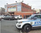  ?? JOHN MINCHILLO/AP ?? New York City police officers work the scene of a police-involved shooting at the 41st Precinct on Sunday.