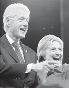  ?? Charlie Neibergall Associated Press ?? BILL AND HILLARY CLINTON greet supporters at an October campaign event in Des Moines. Ron Burkle says he still adores Bill, despite their falling out.