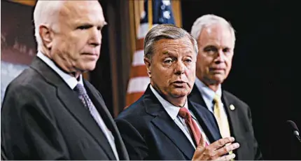  ?? JUSTIN SULLIVAN/GETTY ?? Sen. Lindsey Graham, R-S.C., center, speaks Thursday with Sens. John McCain, R-Ariz., left, and Ron Johnson, R-Wis., saying they would vote for the Senate GOP’s skinny bill if they received a guarantee from House Speaker Paul Ryan, R-Wis., that the...