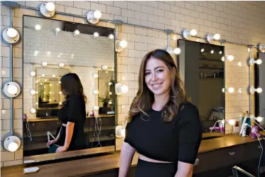  ?? AP Photo/Mark Lennihan ?? ■ Hair salon owner Erika Wasser stands in her Glam+Go studio July 19 in New York. She owns nine salons in three cities.