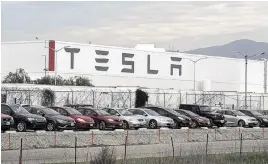  ?? LIPO CHING Bay Area News Group/TNS ?? Cars are lined up near the Tesla Motors factory complex in Fremont, Calif., on Jan. 28, 2016. Like most makers of electric vehicles, Tesla has suffered a decline in vehicle sales.
