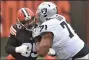  ?? THE ASSOCIATED PRESS ?? Cleveland Browns defensive end Myles Garrett, left, here working against hulking Raiders lineman Denzelle Good on Nov. 1, has tested positive for the coronaviru­s and will miss the team’s home game against the Eagles Sunday.