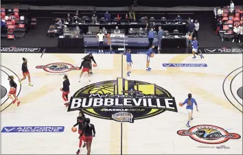  ?? Jessica Hill / Associated Press ?? Louisville and DePaul players warm up before an NCAA college basketball game in Mohegan Sun’s Bubblevill­e on Dec. 4 in Uncasville.