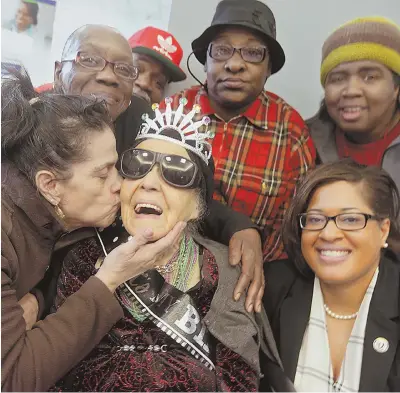  ?? STAFF PHOTO BY JOHN WILCOX ?? QUEEN FOR A DAY: Muriel Walker gets a kiss from Mildred Mercado as she takes a picture with friends during her 100th birthday party. Clockwise from top left are Karen Sanders, Bobby Corry, Jackie Geer, Theresa Suber and state Rep. Chynah Tyler.
