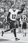  ?? JEFF DEAN/AP ?? Ravens wide receiver Rashod Bateman (12) reacts after a touchdown reception during the first half Sunday against the Bengals in Cincinnati.