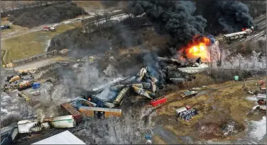  ?? (File Photo/AP/Gene J. Puskar) ?? This photo taken with a drone shows portions of a Norfolk Southern freight train that derailed Feb. 3 in East Palestine, Ohio, and were still on fire at midday Feb. 4. Stories circulatin­g online incorrectl­y claim a photo shows birds that “dropped dead” in Kentucky following the Ohio train derailment, and a video shows birds in northern Indiana that also died from the hazardous chemicals released after the derailment.