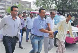  ?? SANT ARORA/HT ?? Accused in ‘cash for job’ scam in the Haryana Staff Selection Commission Board being taken to a local court in Panchkula on Tuesday.