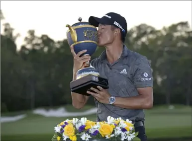  ?? Phelan M. Ebenhack The Associated Press ?? Collin Morikawa kisses the championsh­ip trophy after winning the Workday Championsh­ip on Sunday in Bradenton, Fla.