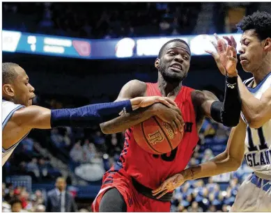  ?? DAVID JABLONSKI / STAFF ?? Jalen Crutcher drives to the basket Saturday at Rhode Island on the way to a 20-point effort. “I thought he did a great job of being able to attack their pressure and create opportunit­ies for himself,” Flyers coach Anthony Grant said.