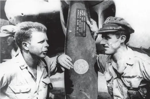  ??  ?? Major Dick Bong of HQ
5th Fighter Command and Major Tom McGuire, CO of the 431st FS, talk by the prop of a P-38J at Hollandia, New Guinea, during April 1944.