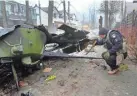  ?? EFREM LUKATSKY/AP ?? A Ukrainian soldier checks a destroyed Russian tank in Irpin, close to Kyiv, Ukraine, on Friday.