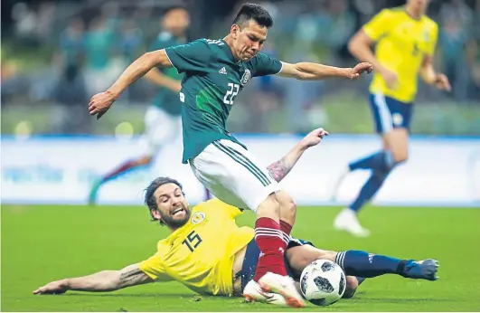  ?? Picture: Getty Images. ?? Charlie Mulgrew slides in to block a Hirving Lozano shot in Scotland’s friendly in Mexico.