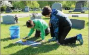  ?? TAWANA ROBERTS — THE NEWS-HERALD ?? All Saints of St. John Vianney School students clean veterans’ headstones at Mentor Cemetery on May 9.