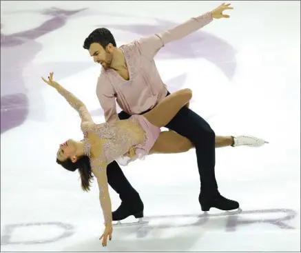  ?? The Associated Press ?? Meagan Duhamel and Eric Radford of Canada compete in the Pairs Free Skating Program during the ISU Grand Prix of Figure Skating Final in Marseille, France, on Friday. The duo finished in third place.