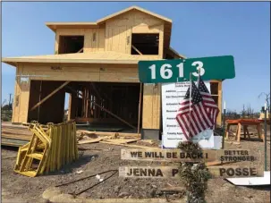  ?? The Associated Press ?? REBUILDING: Signs and flags mark the partially rebuilt home of Debbie and Rick Serdin on Friday in the Coffey Park neighborho­od of Santa Rosa, Calif. The Trump administra­tion’s tariffs have raised the cost of imported lumber, drywall, nails and other key constructi­on materials, squeezing homeowners who seek to rebuild quickly after losing their houses to natural disasters, such as the wildfires that destroyed Coffey Park.