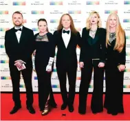  ??  ?? Kennedy Center Honoree Timothy Schmit, center, of the Eagles arrives with his family, from left, Ben Schmit, Jeddrah Leiterding, Owen Schmit, and Jean Schmit at the State Department for the Kennedy Center Honors gala dinner on Saturday.