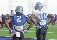  ?? MEMPHIS ATHLETICS ?? Memphis defensive back TJ Carter (2) and wide receiver Damonte Coxie take a break during a Tigers practice.